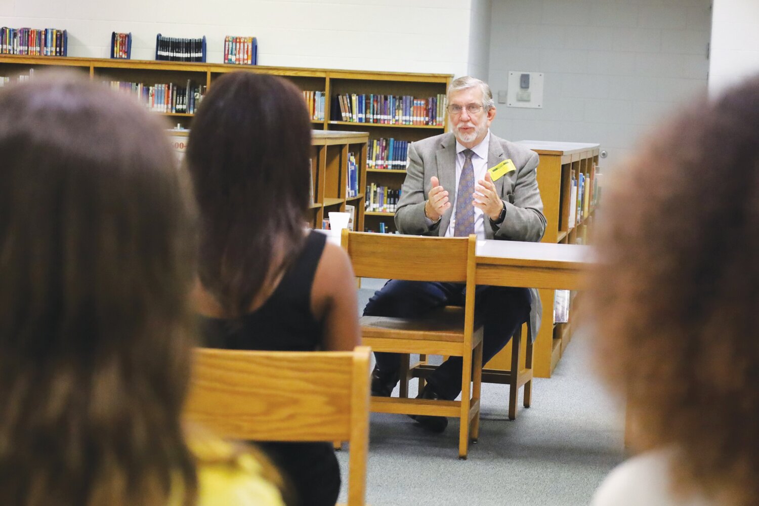 Judge Bryant sharing feedback with Incubate Debate competitors at Osceola Middle School after the preliminary round.